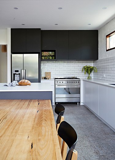 black and white kitchen with black upper cabinetry