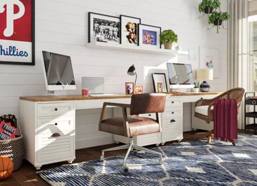 Home Office for Two Matching desks with computer screeens, leather desk chairs, area rug, shiplap wall.