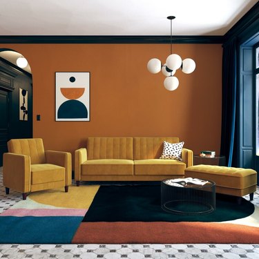 bauhaus colors in living room with yellow couches and orange walls