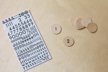 Number stickers adhered to wood circles