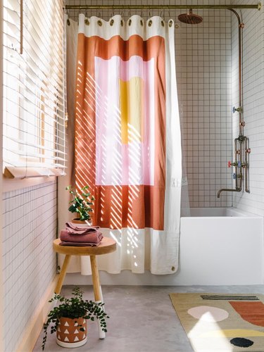 white bathroom with terra cotta color block shower curtain