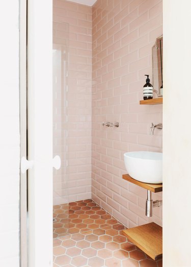 blush bathroom with terra cotta color floor tiles