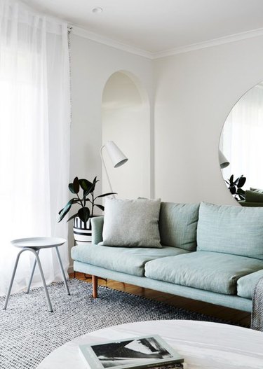 mediterranean-inspired living room with blue sofa and archway