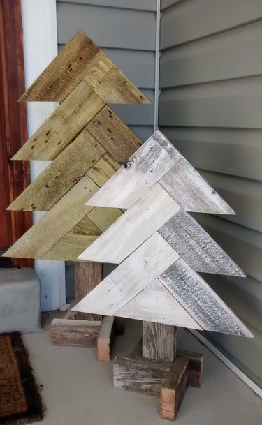 Pallet Christmas trees displaying herringbone patterns in green and white on front porch