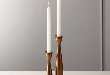 two candle on bronze candle holders