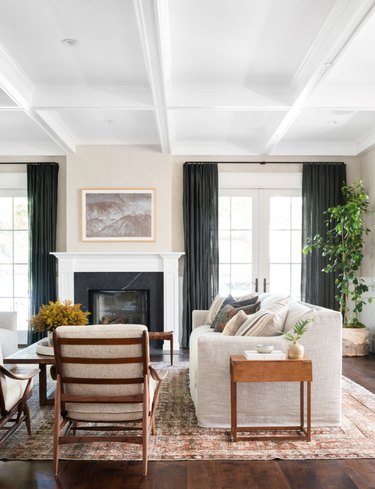 white living room with terra cotta color rug and white furniture