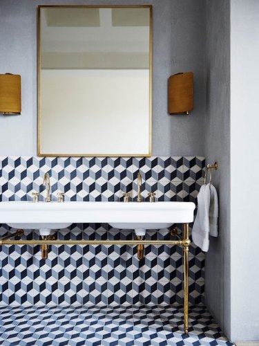 modern bathroom with patterned wall and floor tile