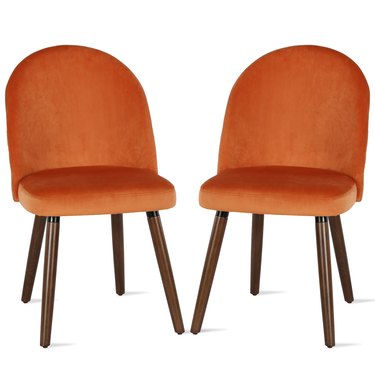 two orange dining chairs