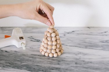 Gluing wood bead on top of foam cone