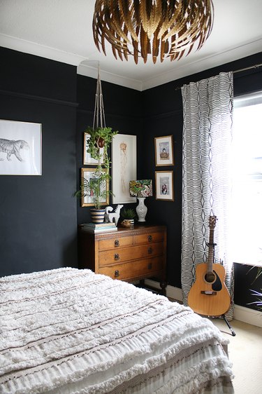 eclectic bedroom with black walls