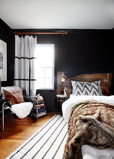 bedroom with black walls and live edge headboard