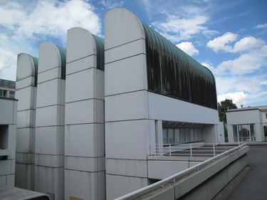 Bauhaus architecture in concrete with curved shapes and glass windows