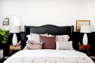 bedroom with black wainscot and black upholstered headboard