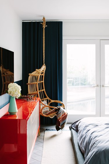 color that goes with navy blue, white room with navy curtains and red credenza and rattan hanging chair