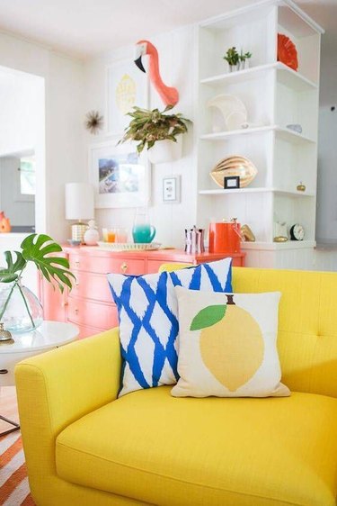 tropical living room with yellow sofa
