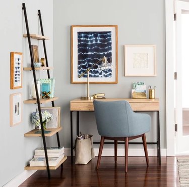 desk space with blue chair and shelf