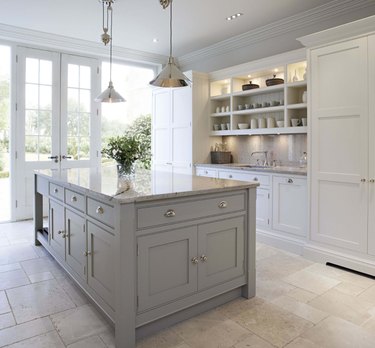 tumbled travertine kitchen flooring with gray cabinets and open shelving