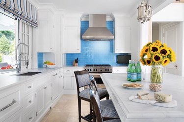 travertine kitchen flooring with blue subway tile backsplash