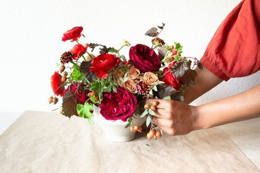 fall-themed floral centerpiece with burgundy flowers