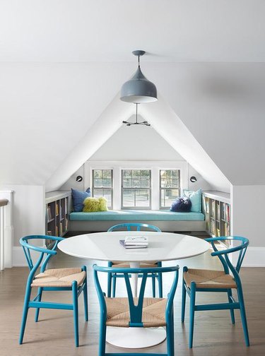 cheerful attic idea with table and chairs and window seat