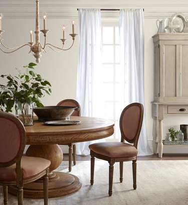 dining room space with beige walls and chandelier