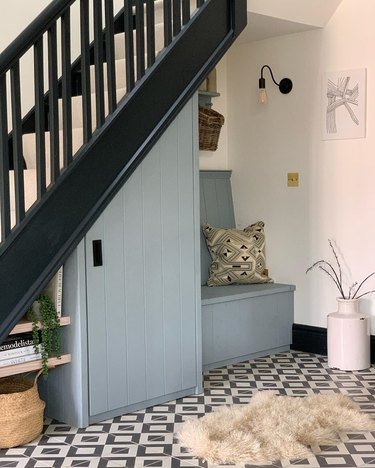 Under the stairs storage with blue painted cupboard and seating