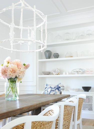 dining room with white chandelier and white built-in storage