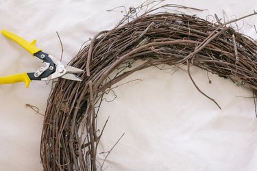 Clipping vine on grapevine wreath