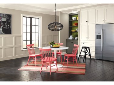 dining room with beige walls and coral chairs