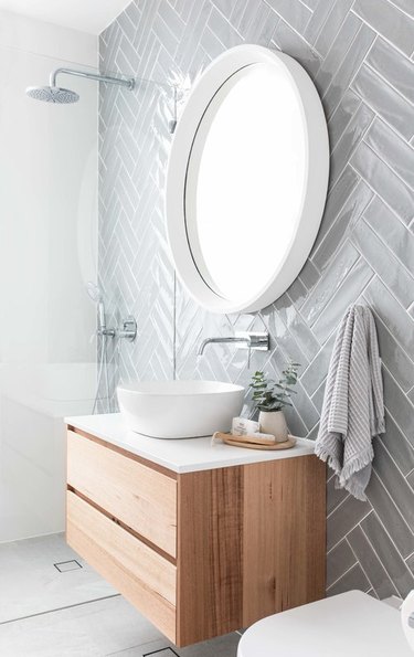 Scandinavian bathroom with herringbone pattern wall tile