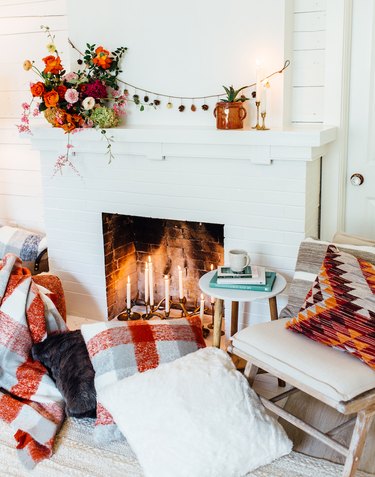 fall-inspired mantel decor with seasonal flowers and garland