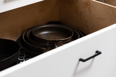 pans stacked in drawer