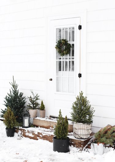 DIY Outdoor Christmas Decorations with Minimalist Christmas front porch with mini trees by The Merry Thought
