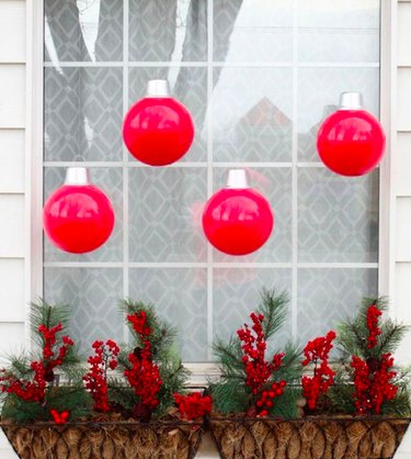DIY oversized red ornaments in window for DIY Outdoor Christmas Decorations