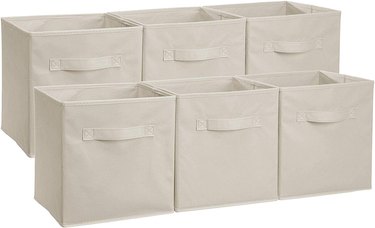 Cream fabric storage containers with handles on white background