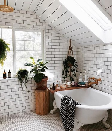 bathroom idea with white subway tile on the walls and mosaic penny tile on the floor with clawfoot tub