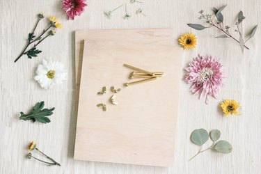 Two plywood boards stacked together with brass bolts and wing nuts