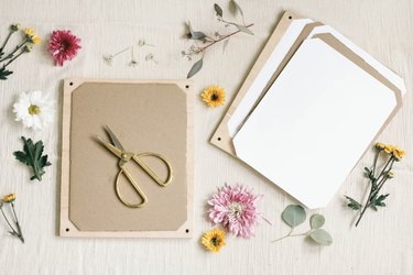 Wood board and gold scissors with flowers