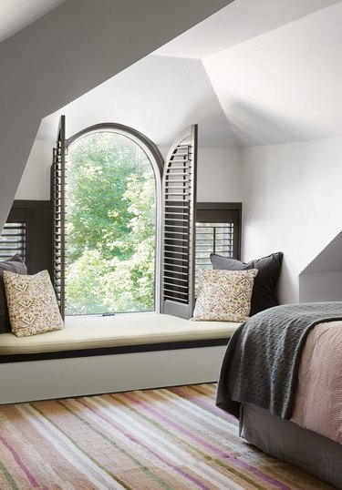 arched window in attic with bench