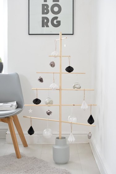 minimal wooden Christmas tree with black-and-white ornaments