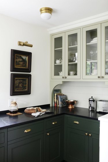 green and gray kitchen with black countertops