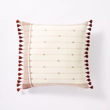 throw pillow with striped pattern and small tassels