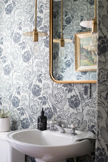 floral patterned wallpaper with brass pendant light