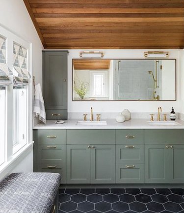 bathroom idea with vanity light bars above mirror and green cabinets