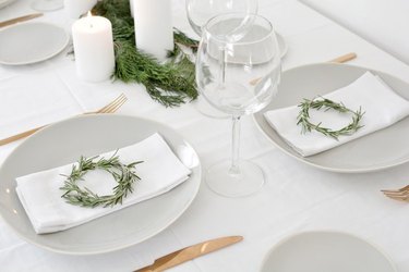 DIY rosemary wreaths for a holiday table setting.