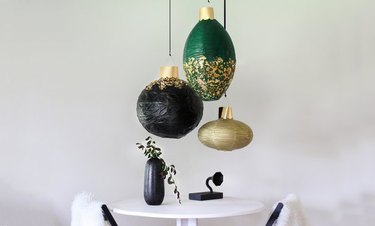 oversize ornaments hanging above dining table