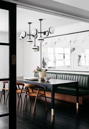 contemporary dining room idea with monochrome statement light