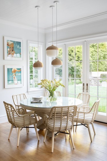 round dining room table idea with hanging pendants above next to French doors