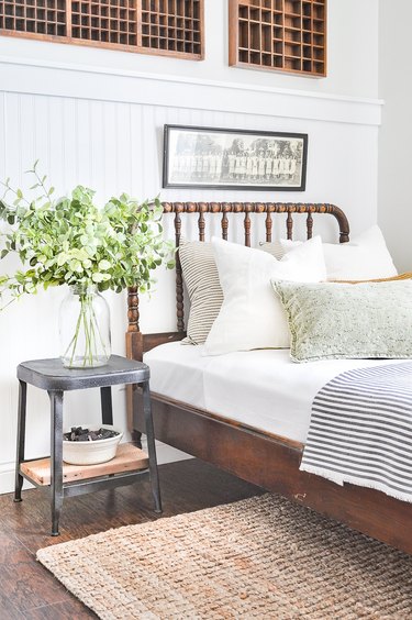 jute rug in farmhouse bedroom under bed