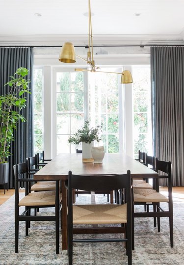 dining room table idea in front of French doors and floor-to-ceiling drapery